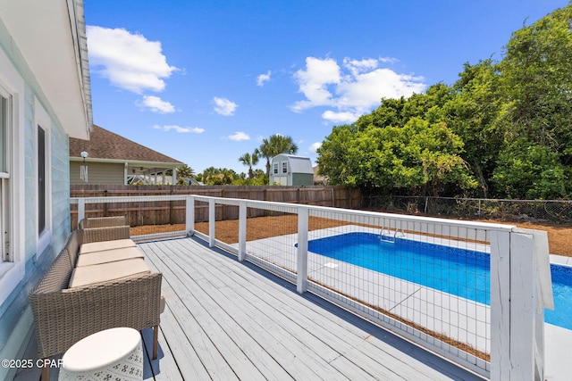 view of swimming pool with a wooden deck