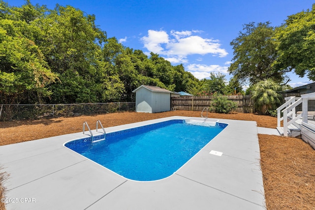 view of swimming pool with a storage unit and a patio