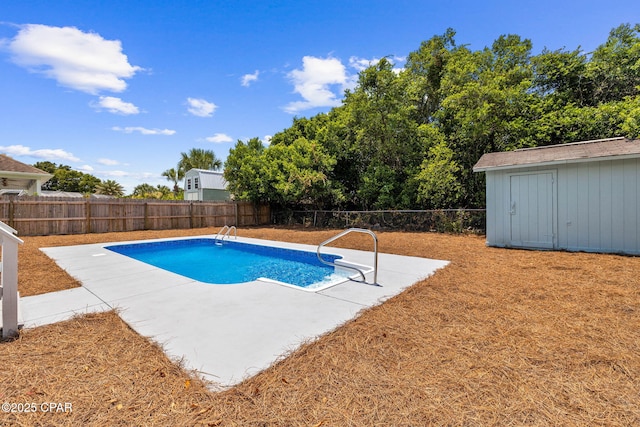 view of swimming pool featuring a storage shed and a patio