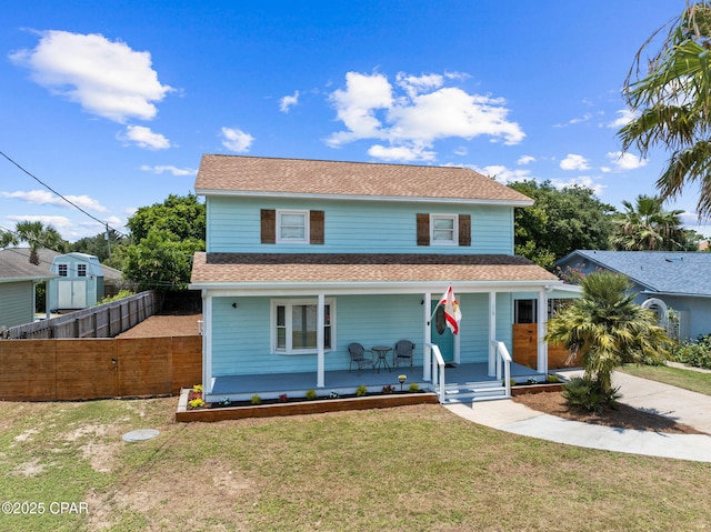 front of property featuring a front yard and covered porch