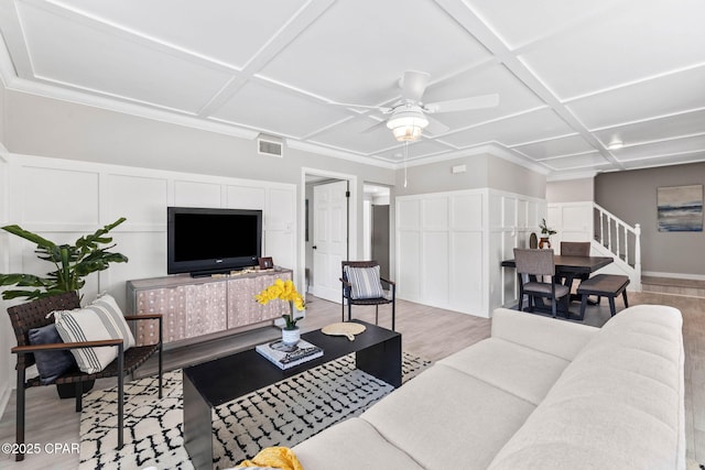 living room featuring coffered ceiling, ceiling fan, and light hardwood / wood-style flooring