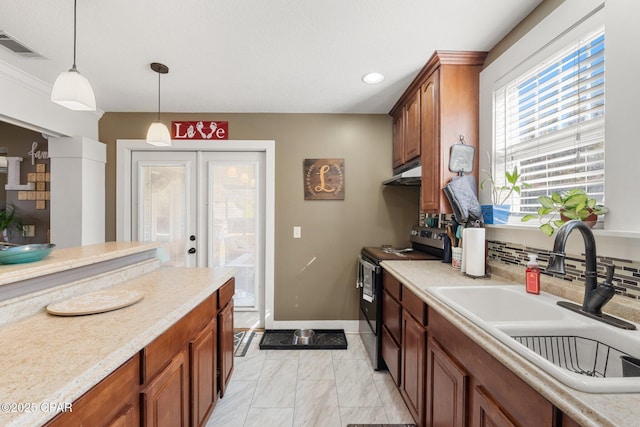 kitchen with sink, stainless steel range with electric stovetop, hanging light fixtures, tasteful backsplash, and french doors