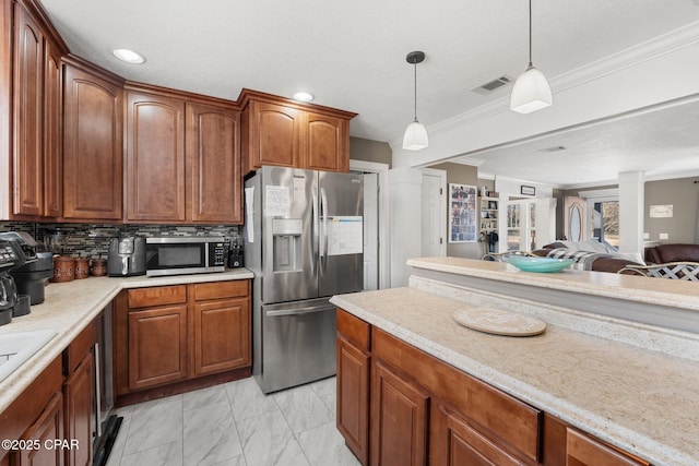 kitchen featuring appliances with stainless steel finishes, decorative columns, decorative backsplash, hanging light fixtures, and ornamental molding