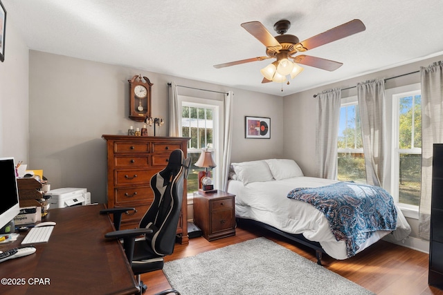 bedroom featuring ceiling fan and light hardwood / wood-style floors