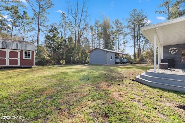 view of yard with a storage shed and a wooden deck