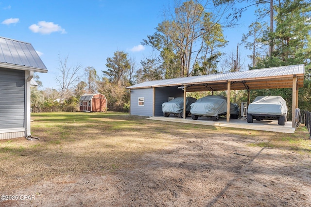 view of yard with a carport and a shed