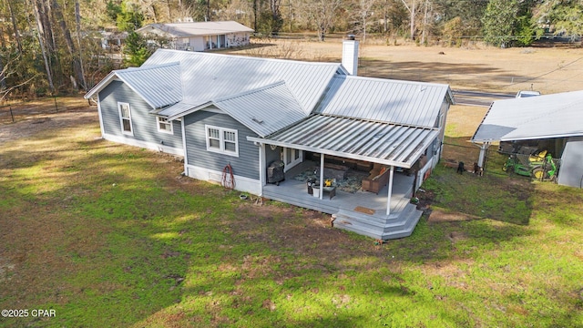 rear view of property featuring a lawn