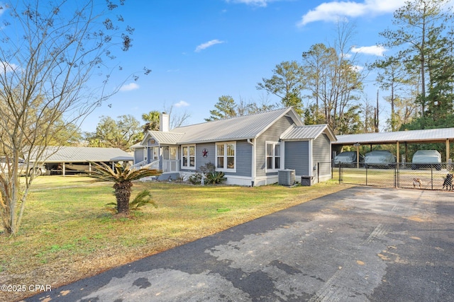 single story home featuring a front yard, covered porch, and central air condition unit