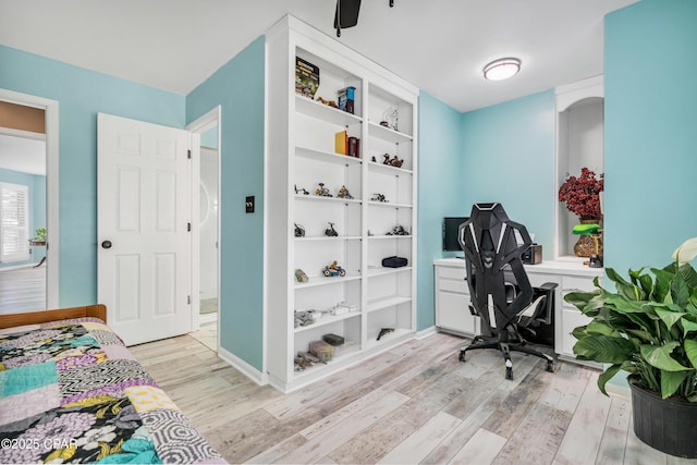 home office featuring baseboards and light wood-style flooring