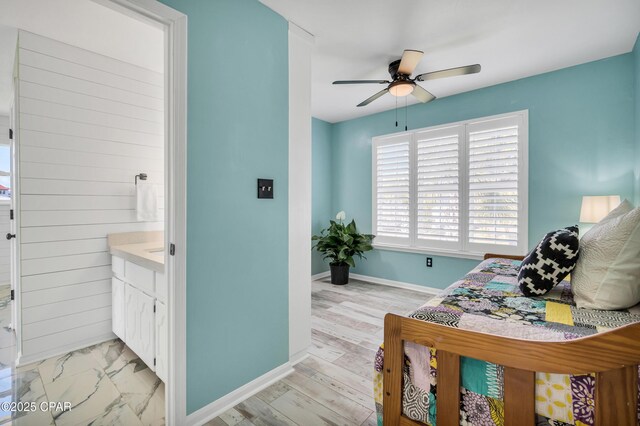 clothes washing area featuring cabinets, washer and clothes dryer, sink, and light wood-type flooring