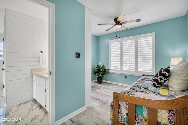 bedroom featuring baseboards, light wood-style floors, and a ceiling fan