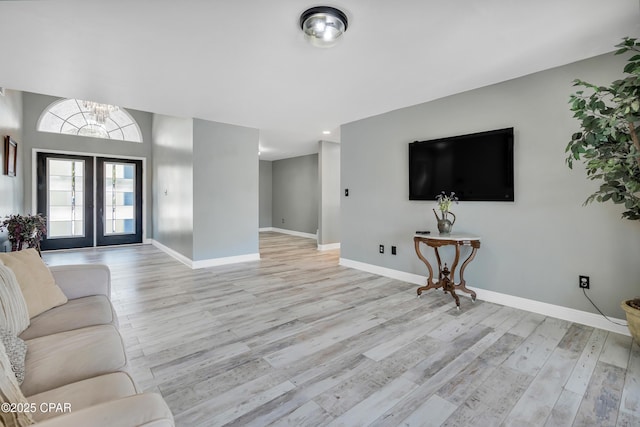 living room with light hardwood / wood-style floors and french doors