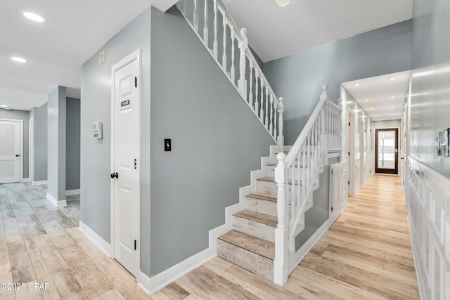 staircase with recessed lighting, baseboards, and hardwood / wood-style floors