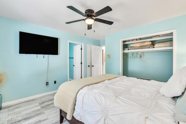 bedroom with visible vents, baseboards, ceiling fan, and wood finished floors