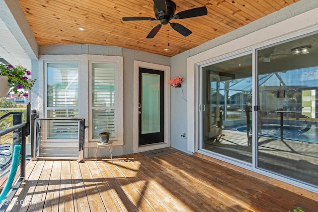 wooden terrace featuring a ceiling fan