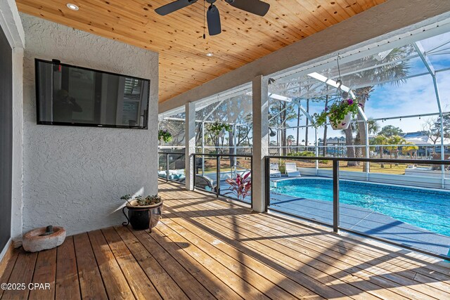 view of swimming pool featuring a lanai