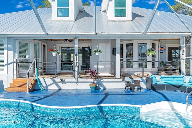 view of pool featuring a patio area, glass enclosure, an outdoor hangout area, and ceiling fan