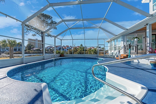 outdoor pool featuring a lanai and a patio area