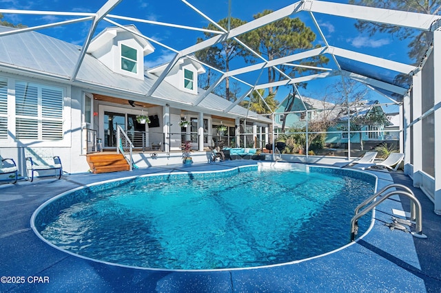 pool featuring a lanai, ceiling fan, and a patio area