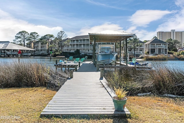 view of dock with boat lift and a water view