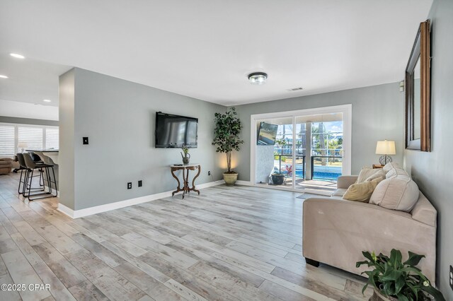 kitchen featuring sink, white cabinets, a center island, stainless steel appliances, and a healthy amount of sunlight