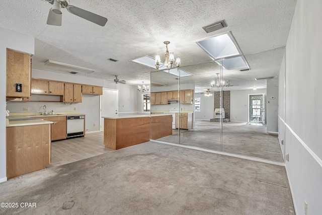 kitchen featuring a kitchen island, decorative light fixtures, sink, stove, and white dishwasher