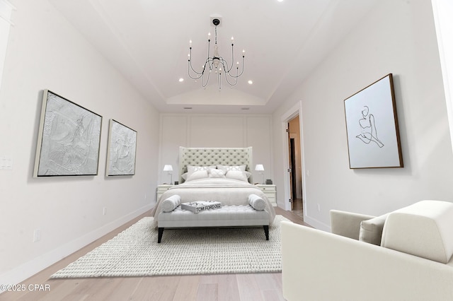 bedroom with light wood finished floors, baseboards, an inviting chandelier, vaulted ceiling, and recessed lighting