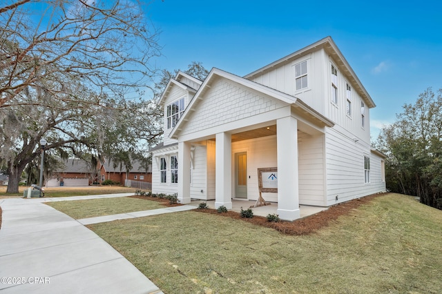 view of front facade featuring board and batten siding and a lawn