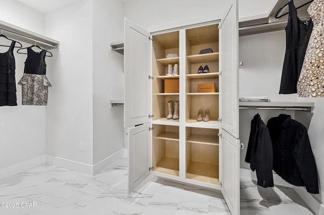 spacious closet with marble finish floor