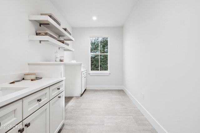 clothes washing area with baseboards