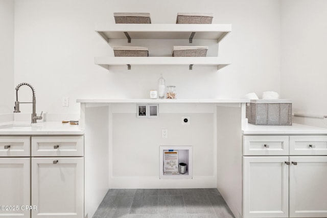 laundry room featuring washer hookup, cabinet space, a sink, and electric dryer hookup