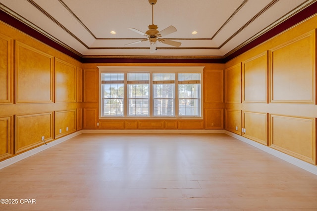 unfurnished room with crown molding, ceiling fan, and light hardwood / wood-style flooring