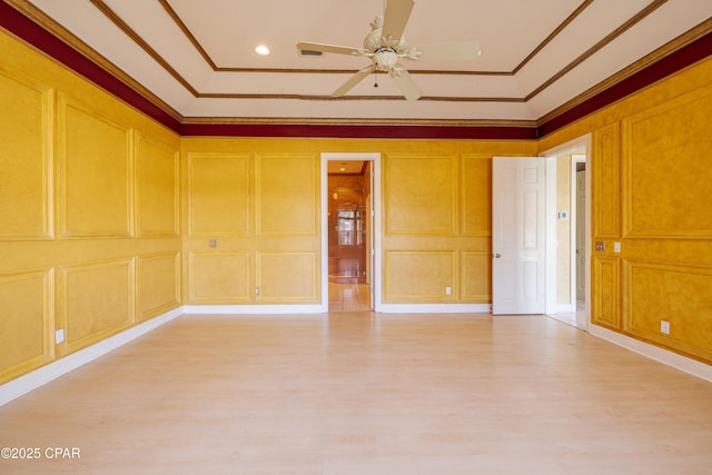 spare room with ornamental molding, light hardwood / wood-style floors, and ceiling fan