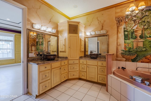 bathroom featuring crown molding, vanity, a relaxing tiled tub, and a textured ceiling