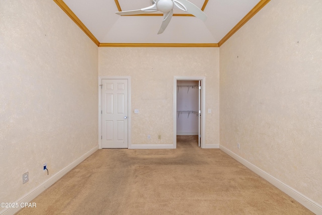 unfurnished bedroom with crown molding, a spacious closet, high vaulted ceiling, and light carpet