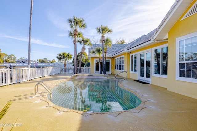 view of pool featuring french doors and a patio area