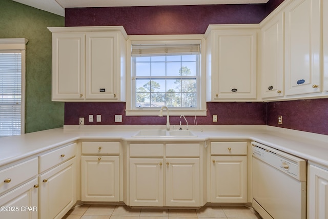 kitchen with white dishwasher, sink, and light tile patterned floors