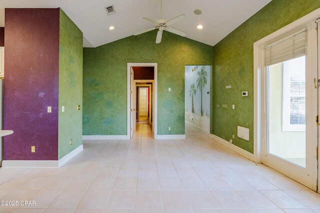 empty room featuring light tile patterned floors, vaulted ceiling, and ceiling fan