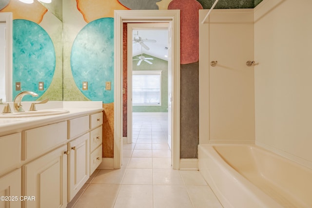 bathroom featuring shower / bathtub combination, lofted ceiling, vanity, ceiling fan, and tile patterned floors