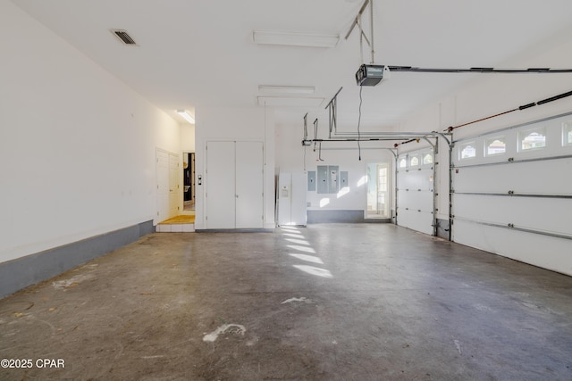 garage featuring a garage door opener and electric panel