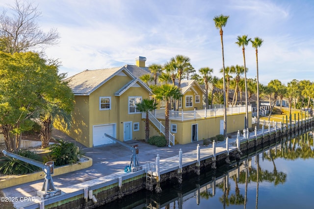 exterior space with a water view and a garage