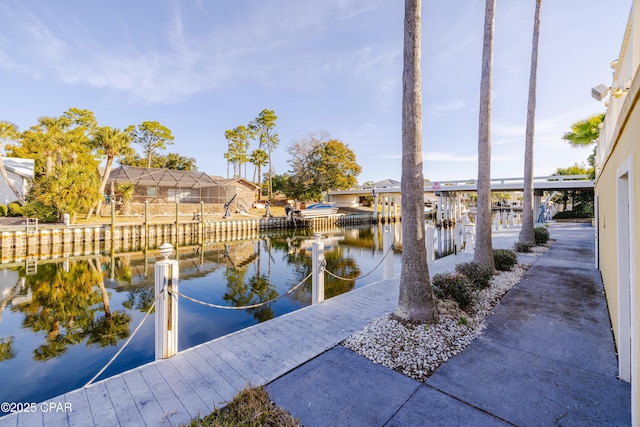 view of community with a boat dock and a water view