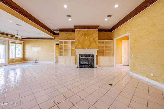 unfurnished living room featuring light tile patterned flooring, crown molding, ceiling fan, and a high end fireplace