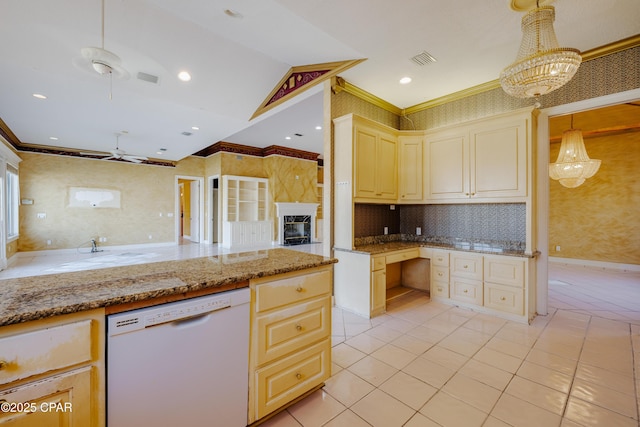 kitchen with cream cabinets, decorative light fixtures, dishwasher, crown molding, and light stone countertops