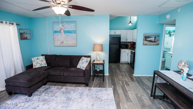 living room featuring hardwood / wood-style floors and ceiling fan