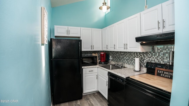 kitchen featuring sink, light hardwood / wood-style flooring, white cabinetry, black appliances, and decorative backsplash