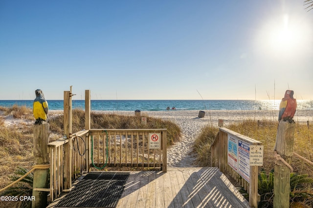 exterior space featuring a water view and a beach view