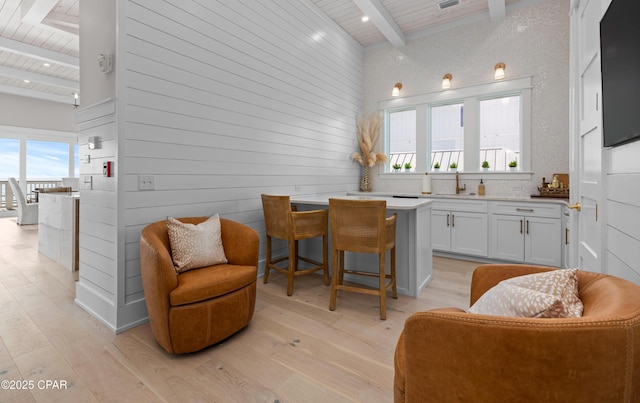 interior space featuring beamed ceiling, a healthy amount of sunlight, and wood ceiling