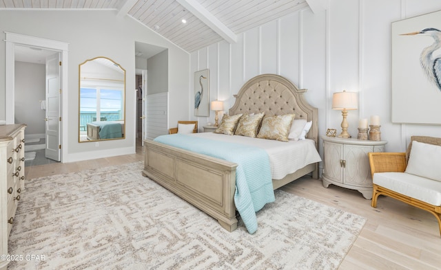 bedroom featuring vaulted ceiling with beams, connected bathroom, wood ceiling, and light wood-type flooring