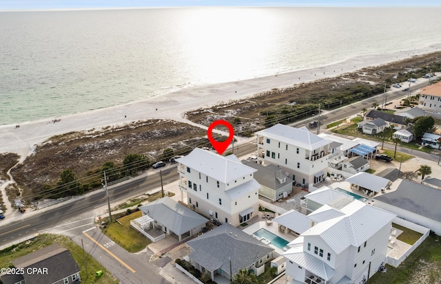 bird's eye view featuring a water view and a beach view